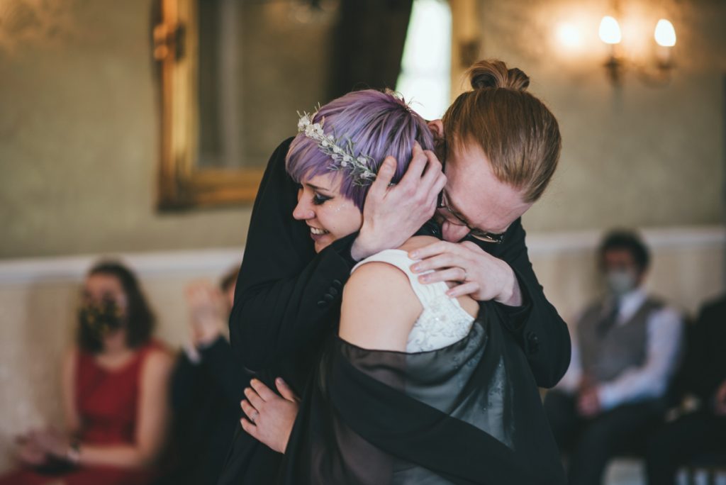 Wedding photographer captures a tender embrace between the bride and groom
