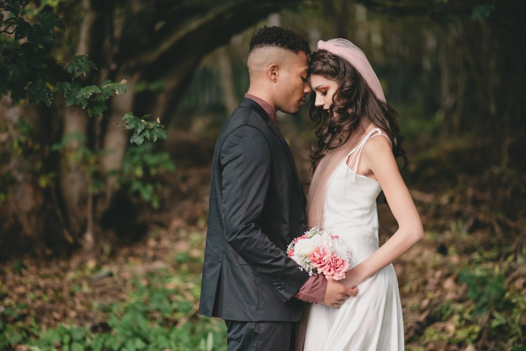 Bride and Groom share a tender moment whilst taking photos with their wedding photographer